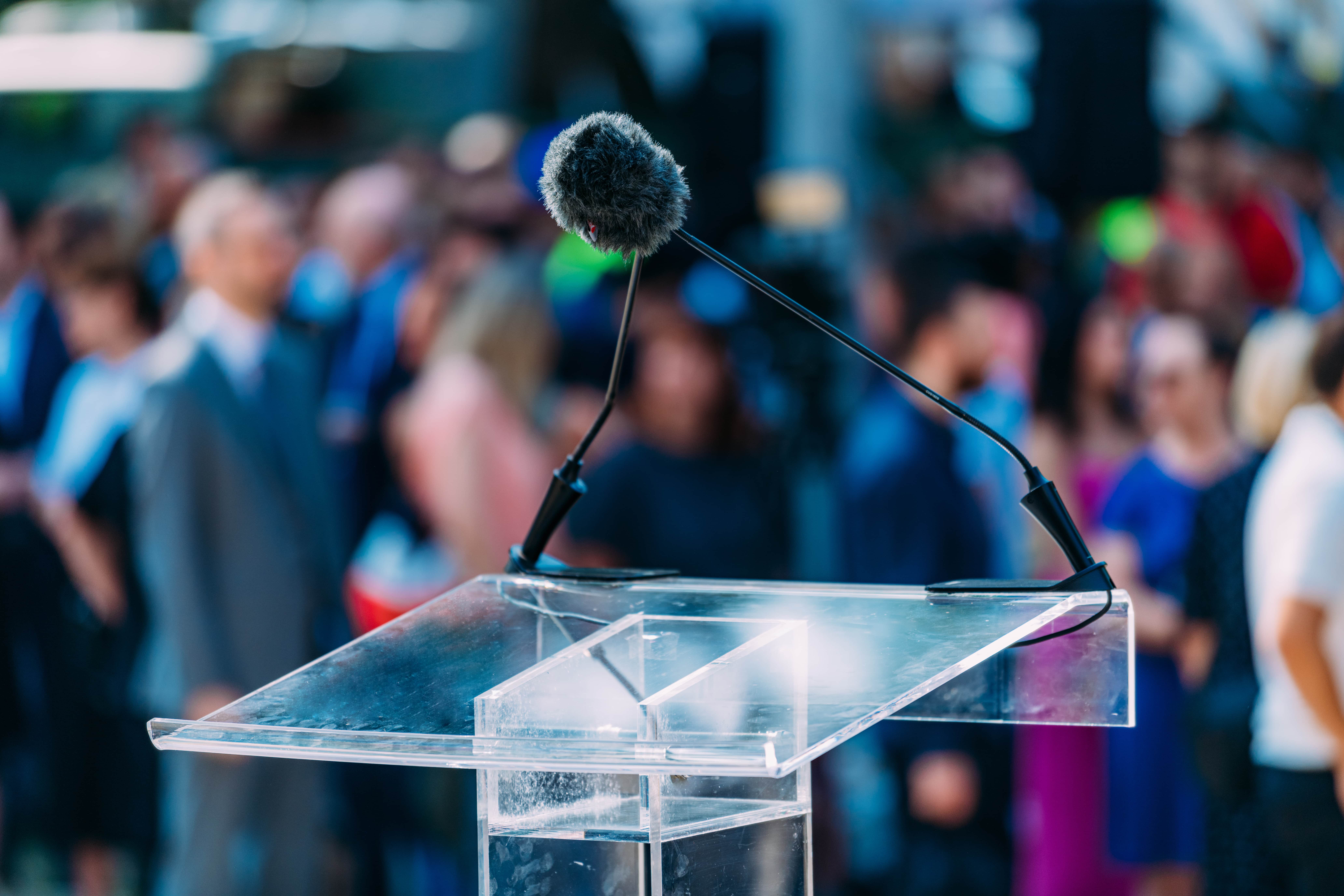 Lectern with a busy crowd in the background
